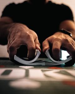 Picture of hands shuffling cards.